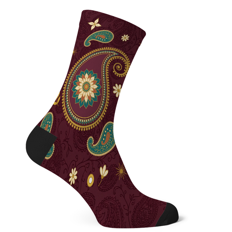 Paisley Socks mockup - one large gold-edged boteh teardrop with a teal and cream rosette in its belly and a gold spiral tail, smaller teardrops and cream daisies around it, on dark wine with tone-on-tone paisley vines, black toe and heel
