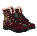 Paisley Winter Boots mockup - pair at a three-quarter angle plus a toe close-up, pale pinkish-cream plush collars, a big gold-beaded boteh with a teal and rust rosette on one boot, a gold-rimmed teal disc on the other, a teal flower on each toe, black laces through open eyelets below two closed studs, deep wine with tone-on-tone paisley