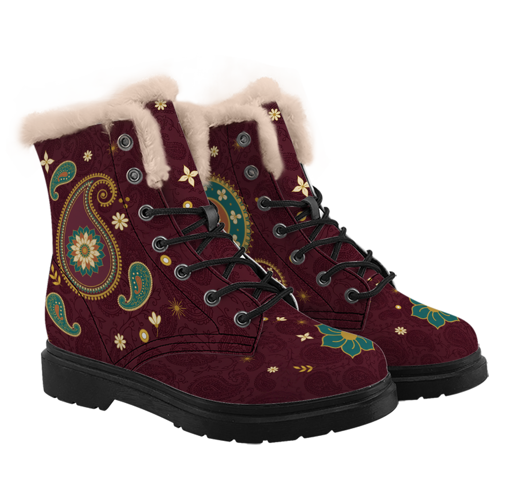 Paisley Winter Boots mockup - pair at a three-quarter angle plus a toe close-up, pale pinkish-cream plush collars, a big gold-beaded boteh with a teal and rust rosette on one boot, a gold-rimmed teal disc on the other, a teal flower on each toe, black laces through open eyelets below two closed studs, deep wine with tone-on-tone paisley