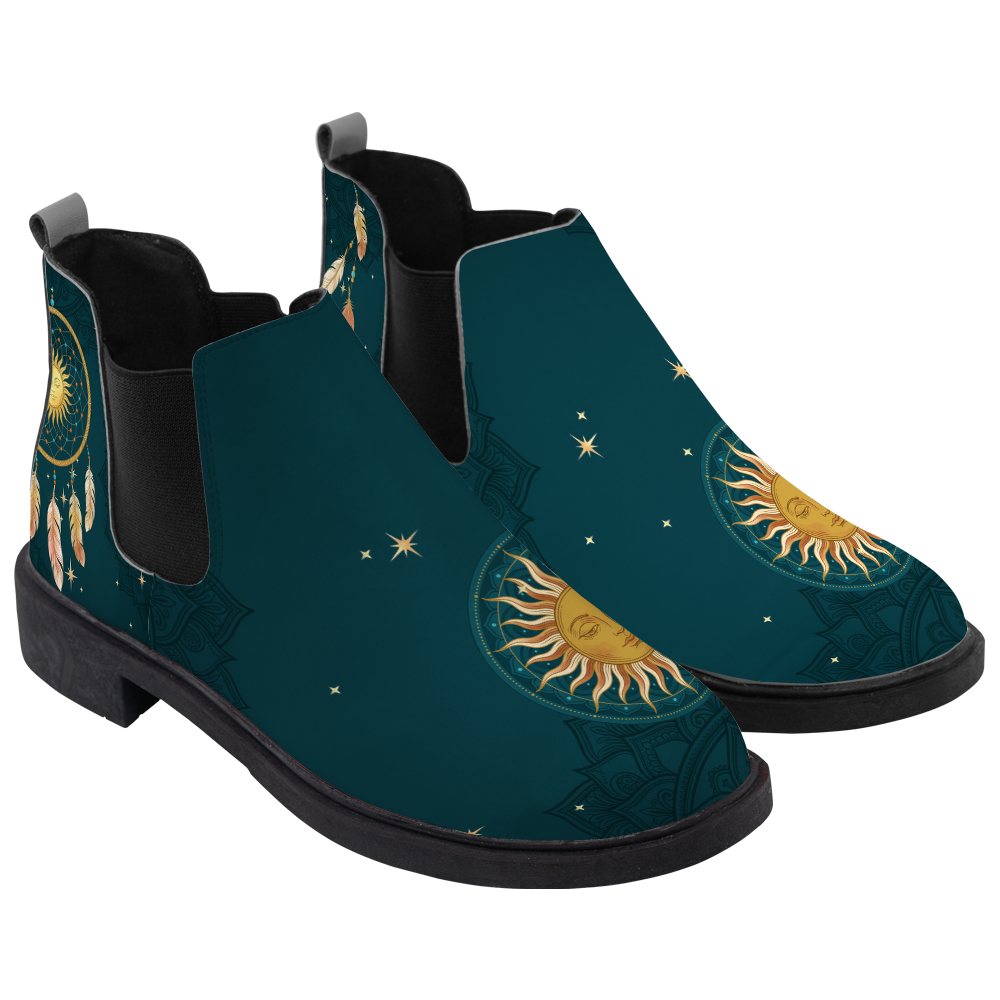 Willow Chelsea Boots, pair in three-quarter view, deep teal with a gold sun face toe and dreamcatcher, white background