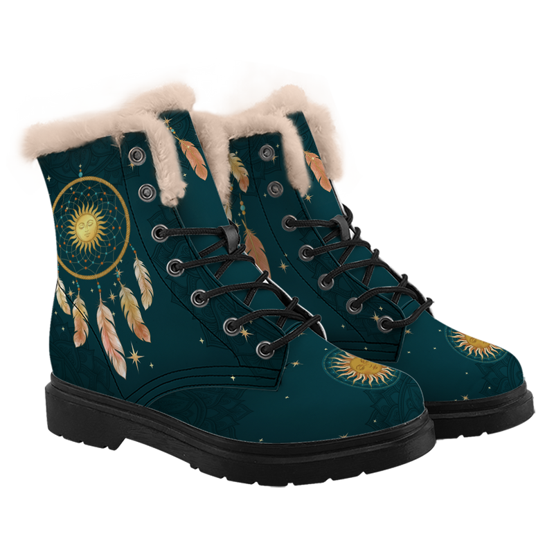 Willow Winter Boots mockup - pair in three-quarter view, cream plush piled round each collar, a gold dreamcatcher on the shaft with a lowered-lid sun face in its web and feathers hanging beneath it, feathers dropping from under the trim, a small gold sun on each toe, black laces, deep teal with tone-on-tone mandalas and gold stars