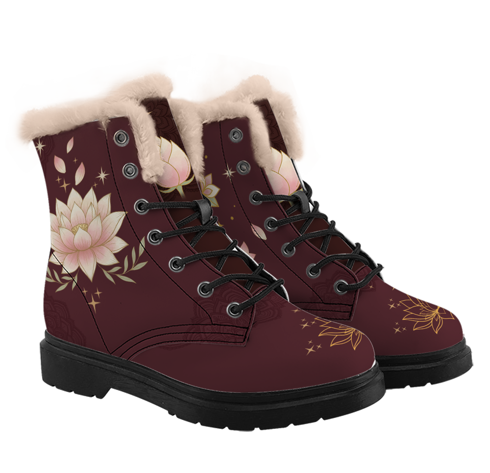 Lotus Winter Boots mockup - a pair from a three-quarter angle, wine boots with thick cream pile trim round each collar. A cream and blush lotus with sage leaves fills the side of one boot, a closed lotus bud sits on the tongue, a gold line lotus with sparks crosses each toe, and black laces through the eyelets.