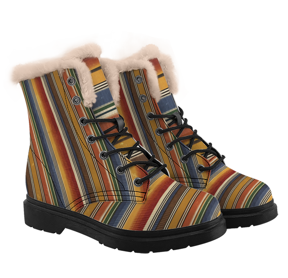 Sedona Winter Boots mockup - three-quarter view of the pair, serape stripes in rust, mustard, denim blue, olive green, brown and fine cream hairlines running upright up each shaft and turning to run across the tongue and toe, a thick pale plush ring round the top of each boot, black laces through five eyelets below two closed studs.