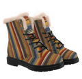 Sedona Winter Boots mockup - three-quarter view of the pair, serape stripes in rust, mustard, denim blue, olive green, brown and fine cream hairlines running upright up each shaft and turning to run across the tongue and toe, a thick pale plush ring round the top of each boot, black laces through five eyelets below two closed studs.