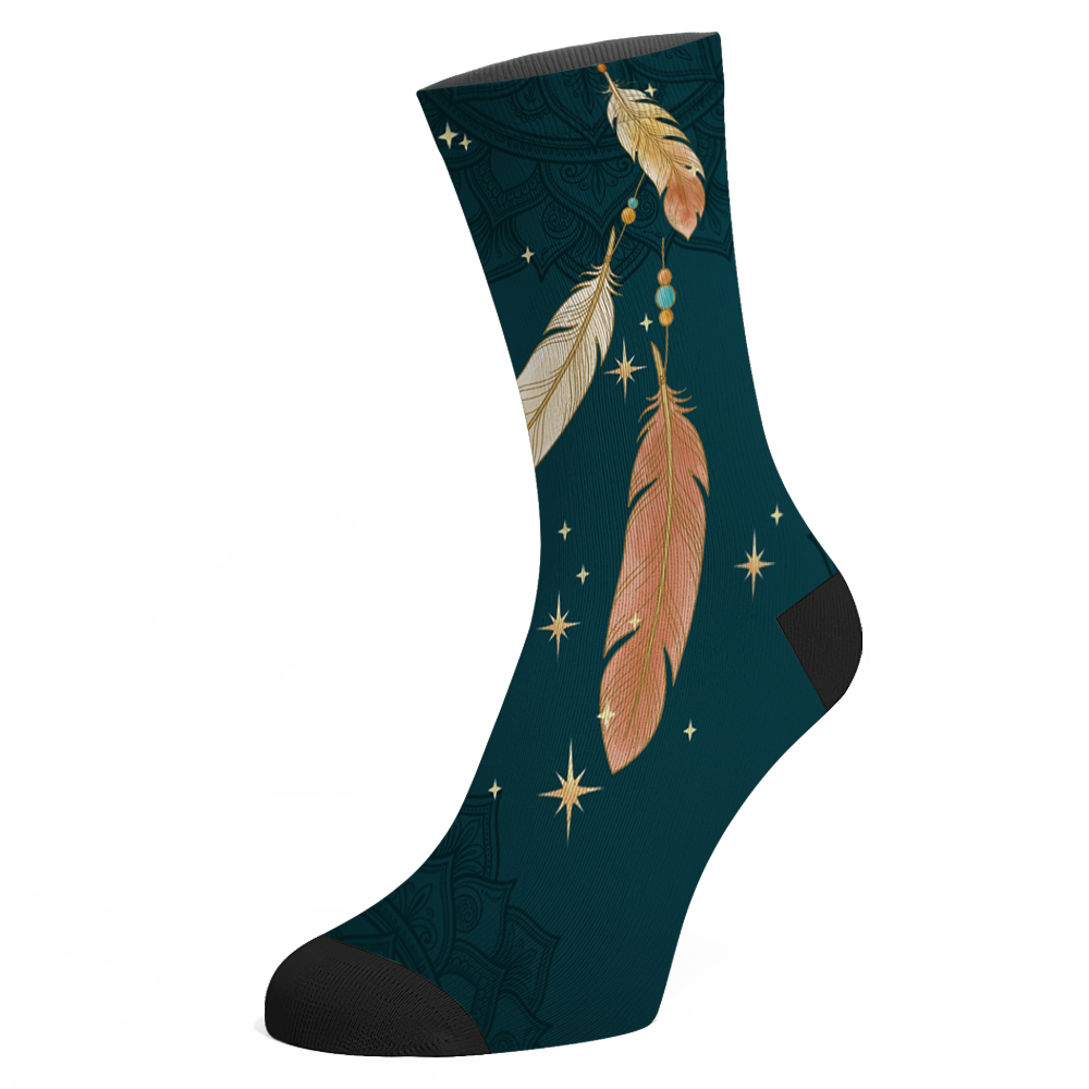 Willow Socks mockup - the second design with no hoop, three feathers falling on beaded gold threads among scattered gold stars on deep teal, black toe and heel