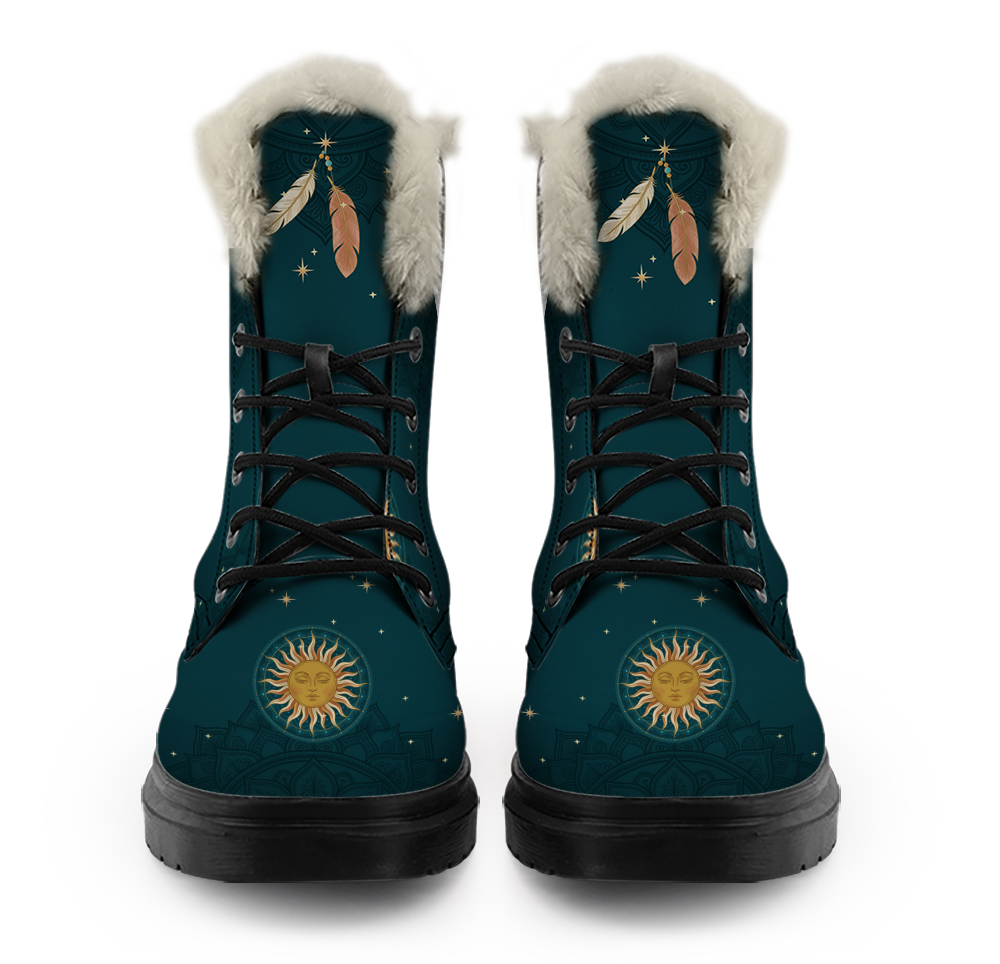 Willow Winter Boots mockup - pair seen straight from the front, pale plush trim at each collar, a gold star and beaded thread with cream and blush feathers hanging from under the trim, black laces crossed through the eyelets, a gold sun face inside a dotted ring on each round toe, deep teal with tone-on-tone mandalas and gold stars
