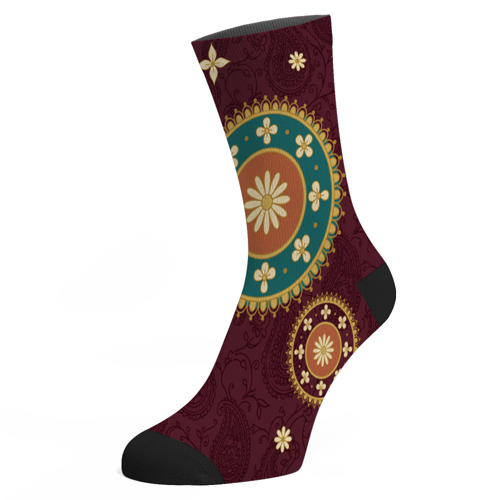 Paisley Socks mockup - the second design, a gold-crowned roundel with a teal ring of cream blossoms and an orange centre holding a cream daisy, a half-size roundel lower down, on dark wine, black toe and heel