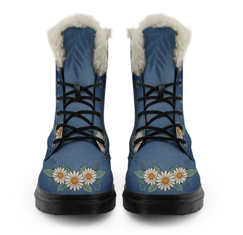Daisy Winter Boots mockup - straight-on front view of the pair, off-white plush trim rolled over each collar, fern fronds printed a little darker than the washed denim blue and running down from the trim, black laces crossing five open eyelets a side, and a row of cream-white daisies with amber middles across each toe.