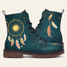Teal boots with a gold dreamcatcher around a sleeping sun face and feathers hanging below
