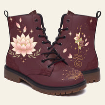 Deep burgundy boots with a pale pink lotus, a gold unalome and scattered petals