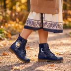Celeste Leather Boots — worn on foot by a woman, showing the celestial sun & moon design with gold moon phases