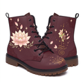 Lotus Leather Boots — studio shot on white with both faces visible, a large cream and blush lotus flanked by sage leaf sprays on one boot, a smaller lotus standing on a gold unalome on the other, deep wine upper