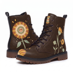Sunny Leather Boots — the pair on a plain white background from both faces, a large rust and gold sunflower with a cream peace sign at the middle on one boot, slim sage-stemmed blooms on the other, dark chocolate brown upper
